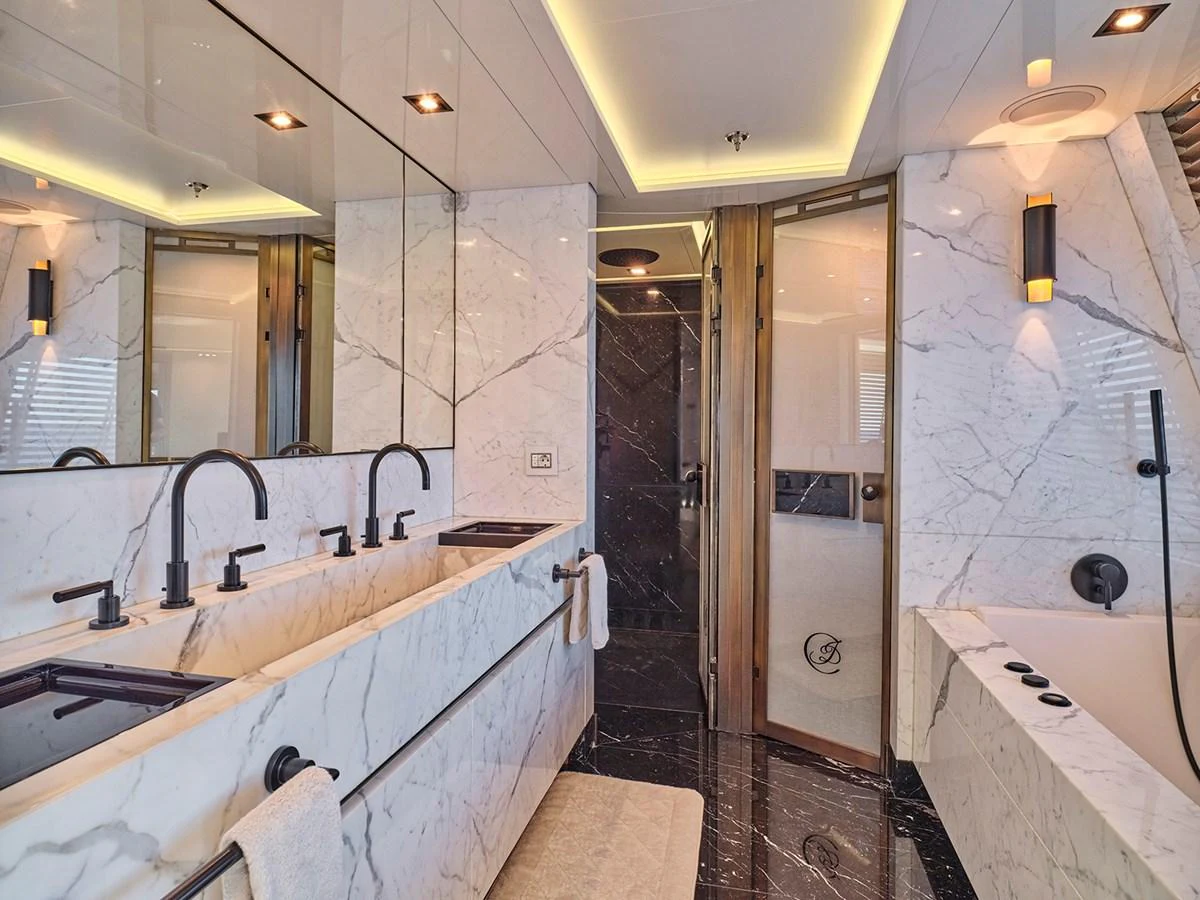 The bathroom features luxurious marble finishes and modern fixtures, creating an elegant and serene space. aboard BELITA Yacht for Sale