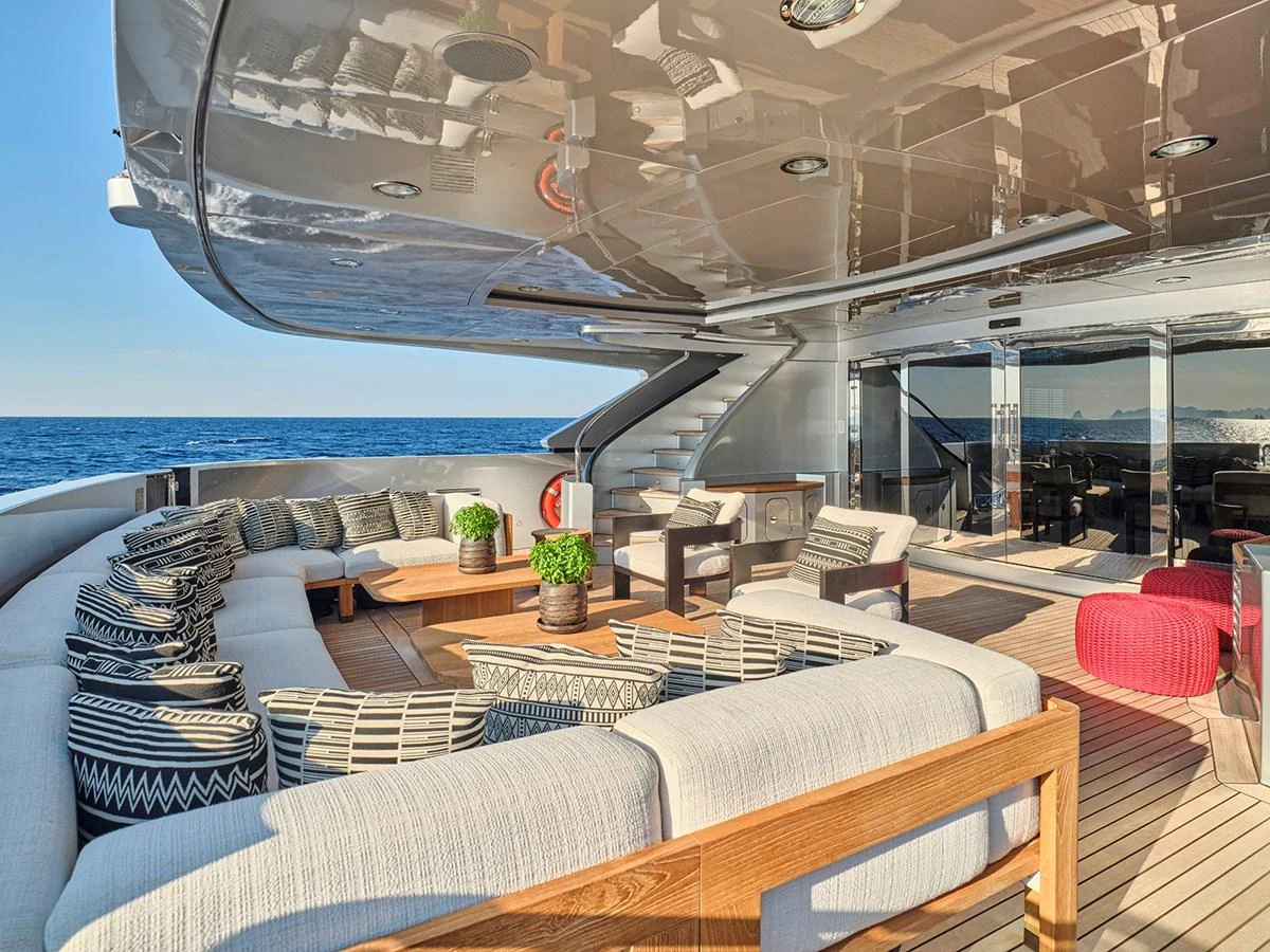 The aft deck features a spacious and stylish seating area with plush cushions and a beautiful ocean view. aboard BELITA Yacht for Sale