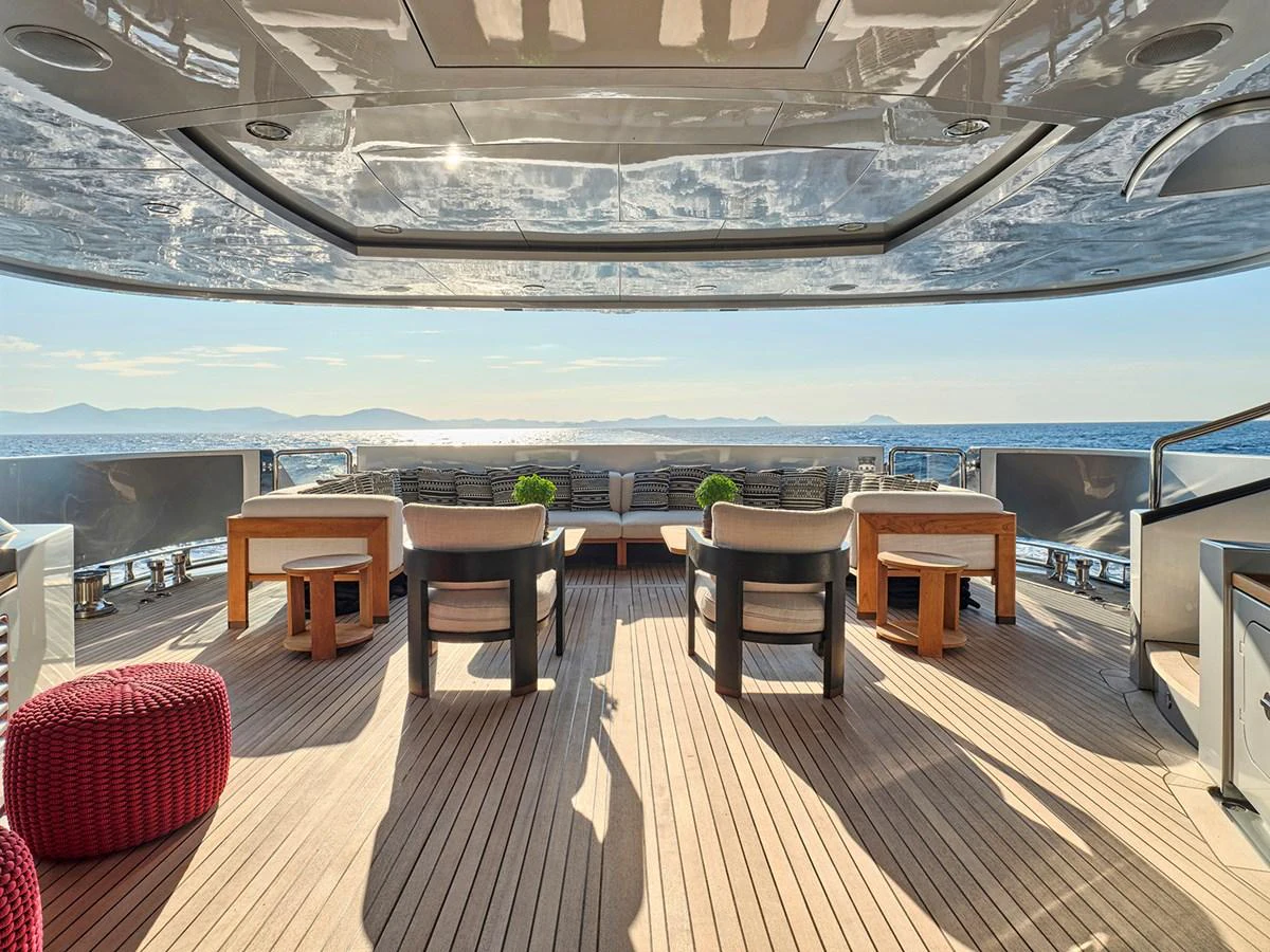 The aft deck offers a spacious and luxurious outdoor seating area with stunning ocean views. aboard BELITA Yacht for Sale