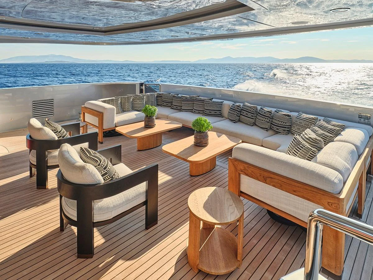 The aft deck offers a spacious and luxurious outdoor seating area with stunning ocean views. aboard BELITA Yacht for Sale