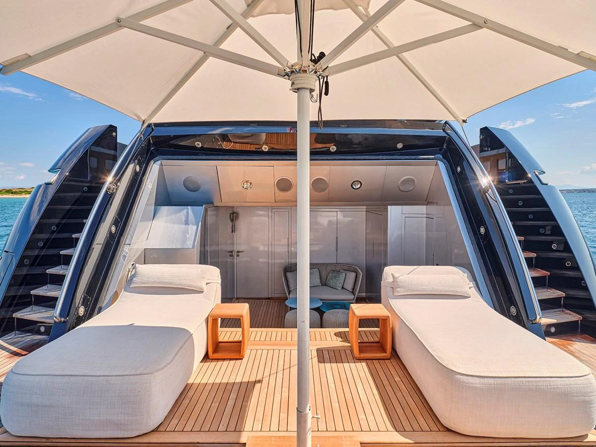 The sundeck offers luxurious lounging with plush sunbeds under a large parasol. aboard BELITA Yacht for Sale