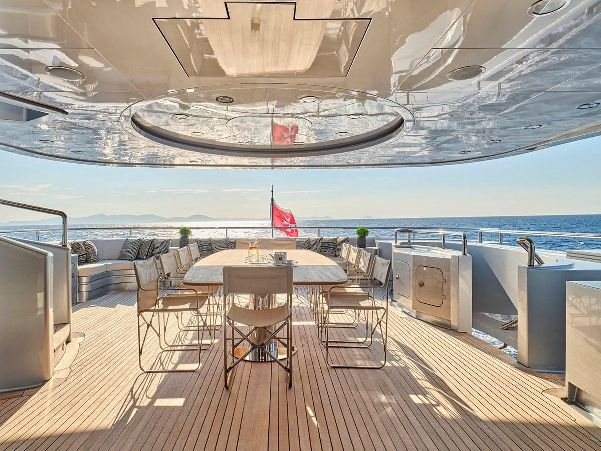 The aft deck features a spacious dining area with a stunning ocean view. aboard BELITA Yacht for Sale