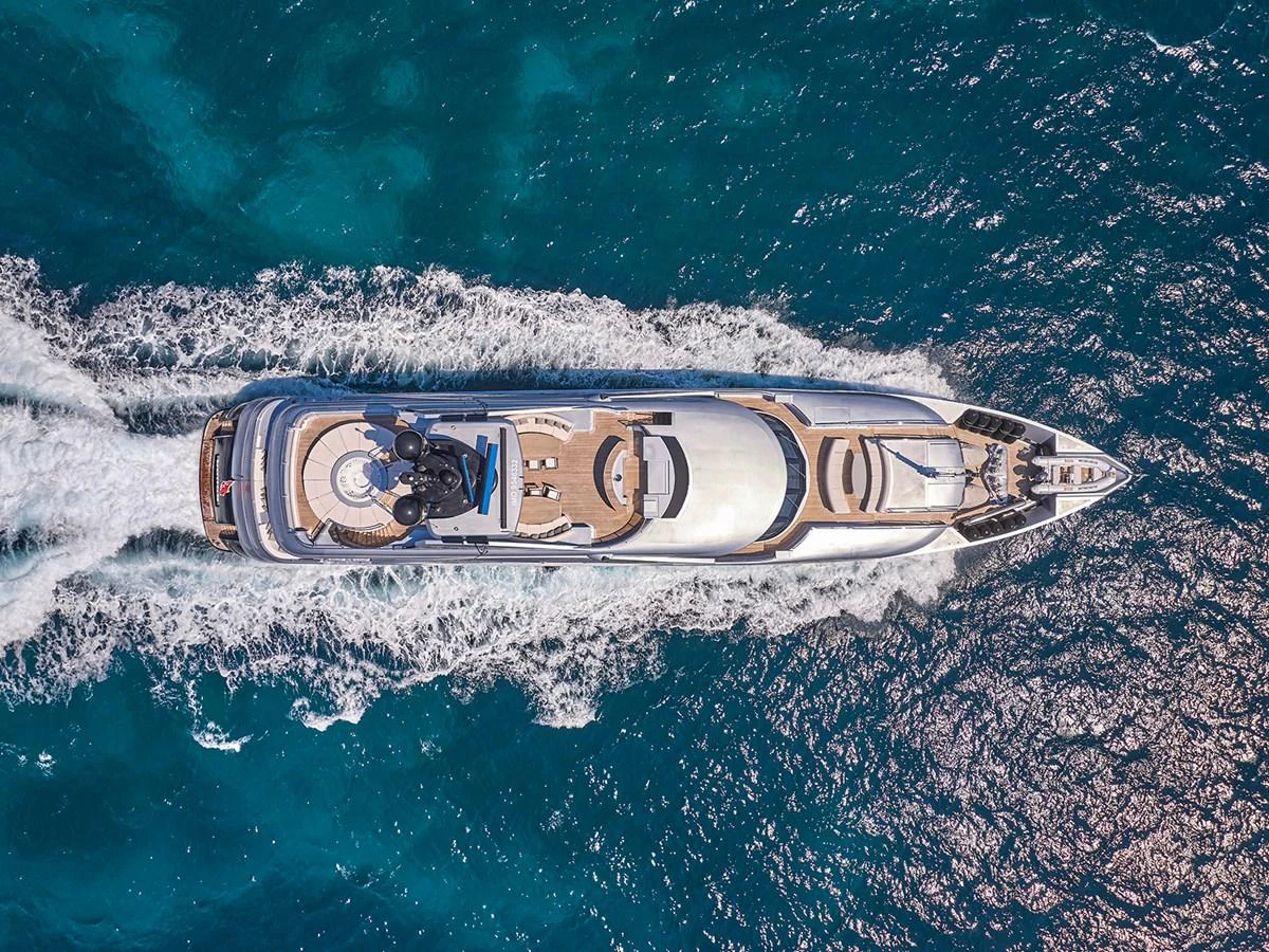An aerial view of a luxurious yacht cruising through clear blue waters. aboard BELITA Yacht for Sale