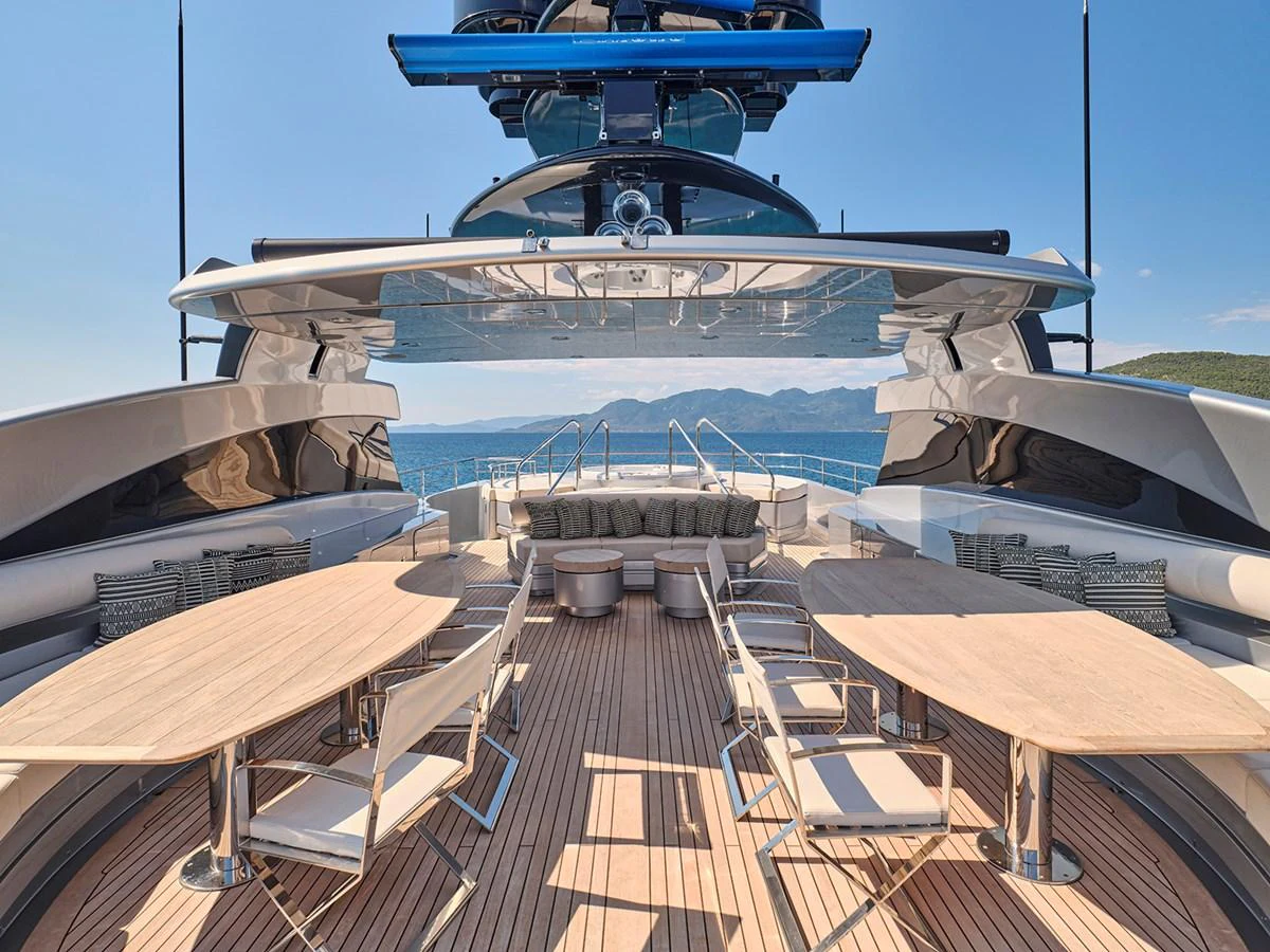 The aft deck offers a spacious and stylish outdoor dining area with stunning ocean views. aboard BELITA Yacht for Sale
