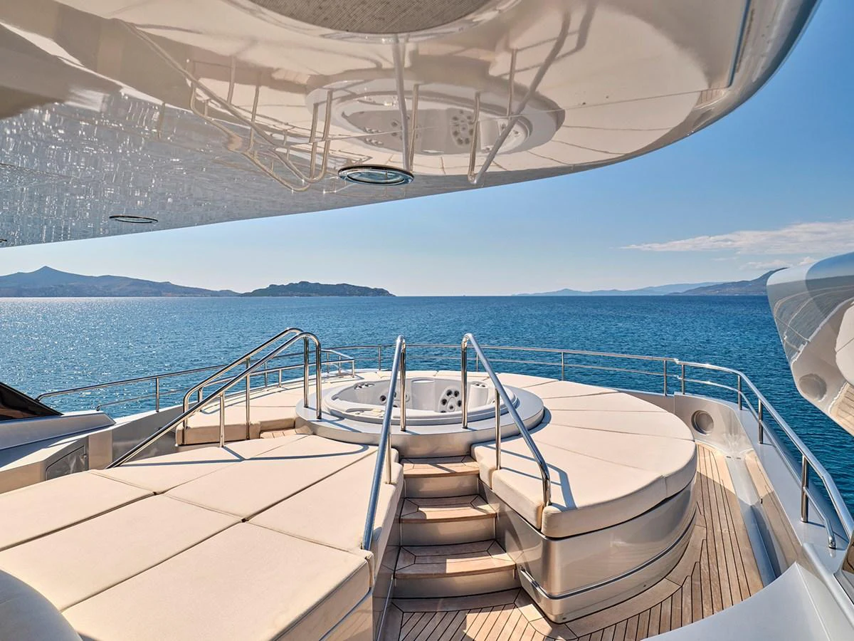 The sundeck features a luxurious jacuzzi surrounded by comfortable sun pads, offering stunning ocean views. aboard BELITA Yacht for Sale