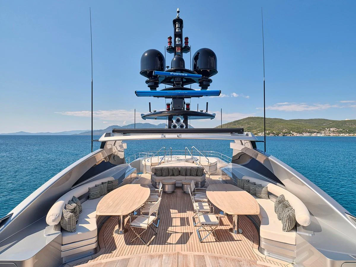 The yacht's flybridge offers a spacious and luxurious outdoor seating area with stunning views of the sea. aboard BELITA Yacht for Sale