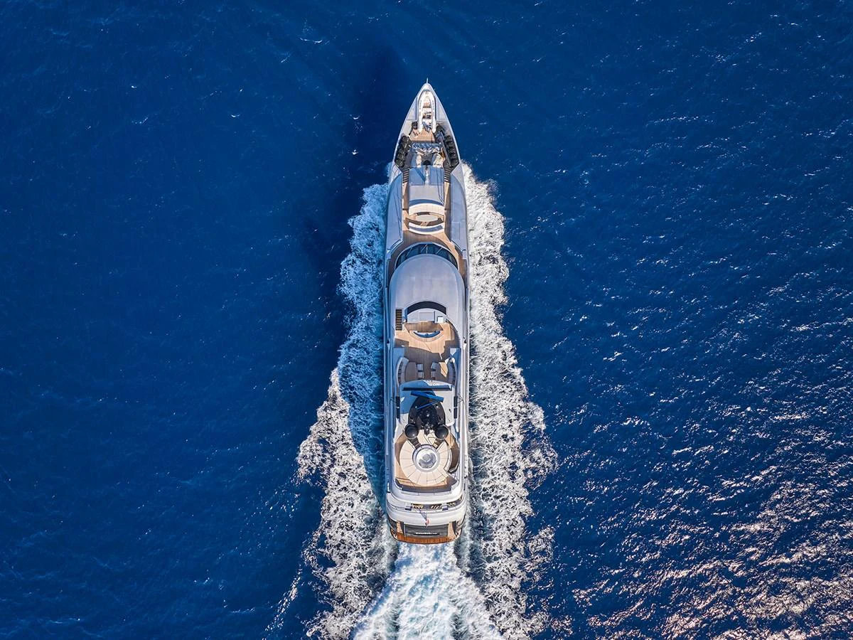 An aerial view of a luxurious yacht cruising through deep blue waters. aboard BELITA Yacht for Sale
