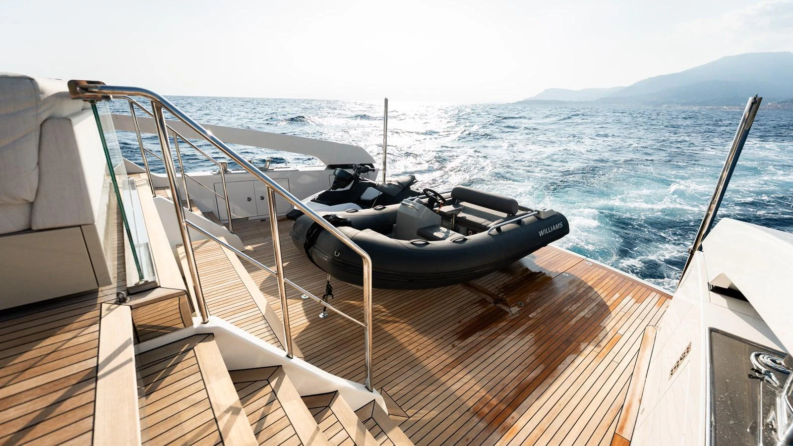 The aft deck features a tender ready for adventure on the open sea. aboard LA Yacht for Sale