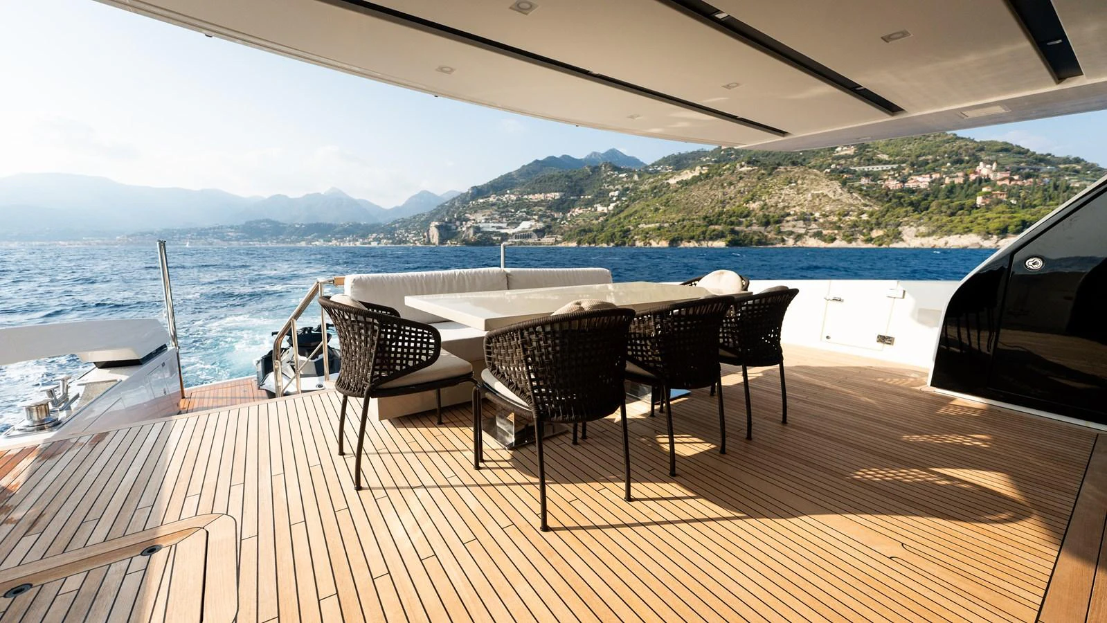 The aft deck features a spacious dining area with stunning views of the sea and coastline. aboard LA Yacht for Sale