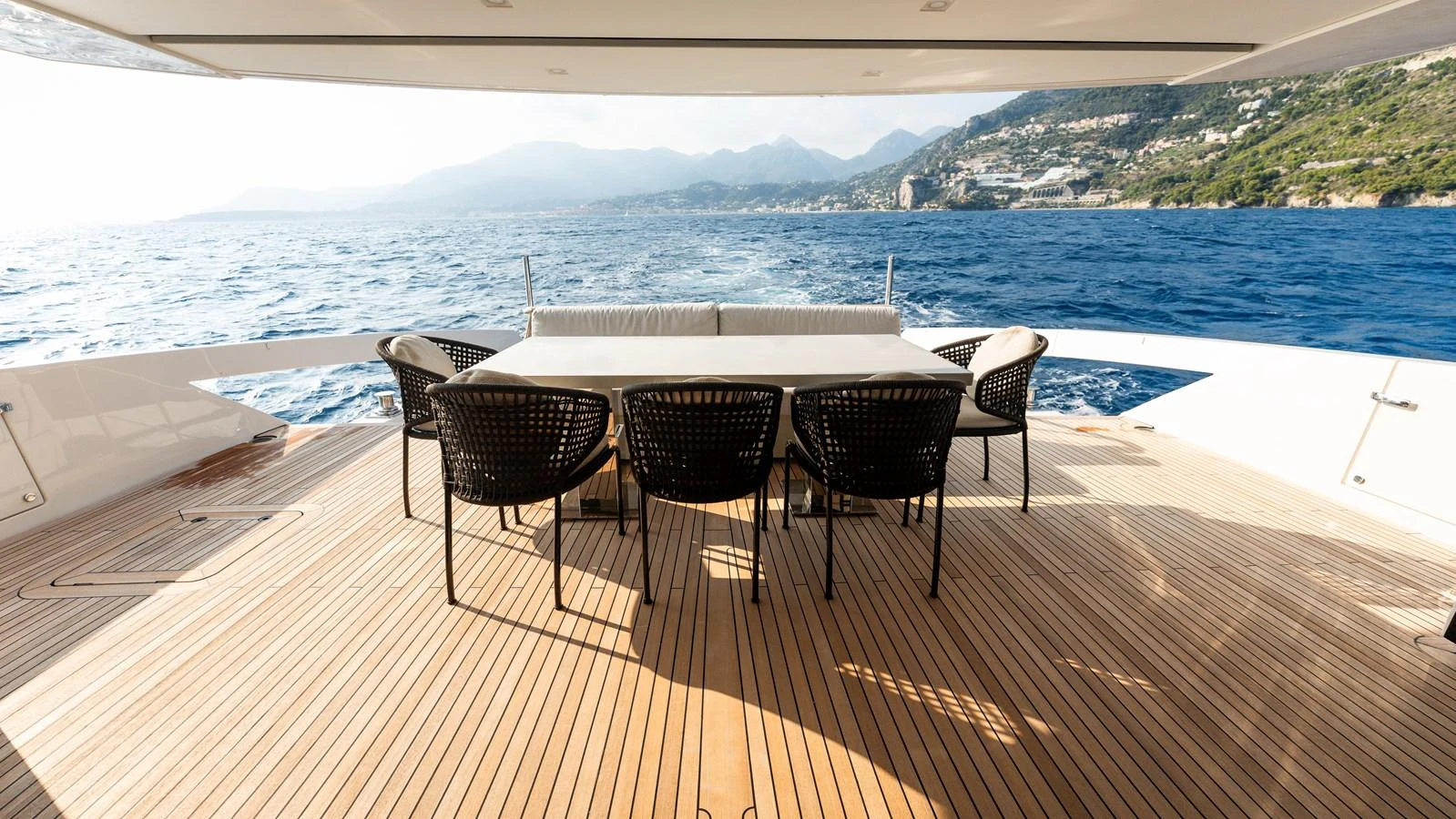 The aft deck features a spacious dining area with stunning ocean views. aboard LA Yacht for Sale