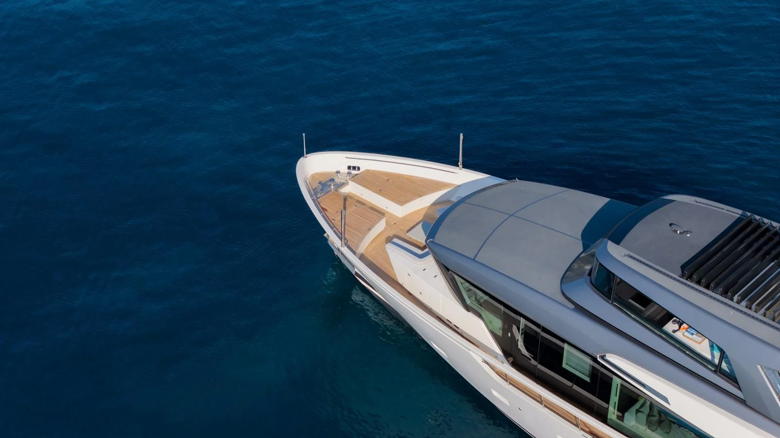 The yacht glides gracefully over the deep blue sea, showcasing its sleek design and luxurious deck space. aboard LA Yacht for Sale