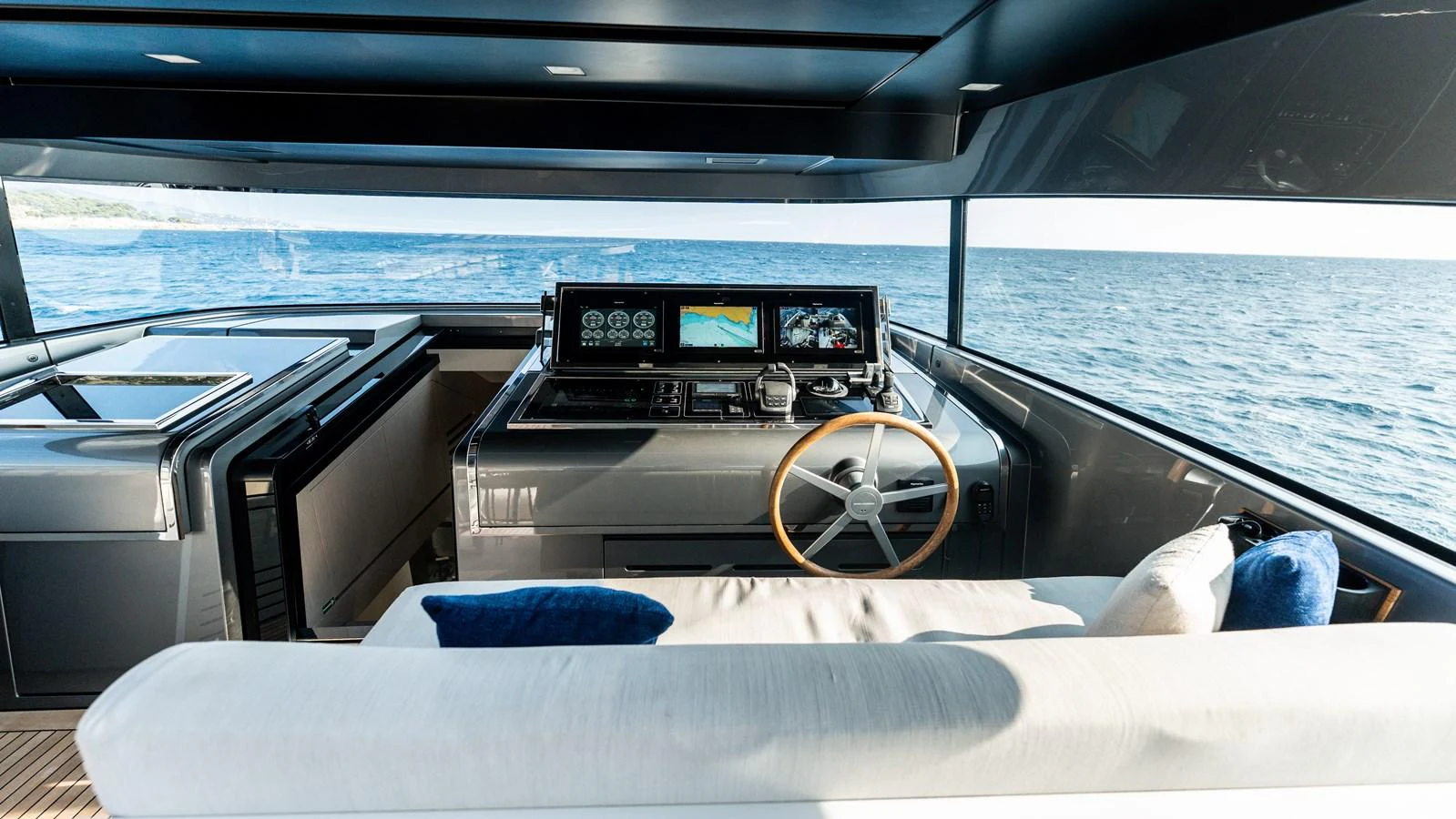 The helm station offers a sleek and modern design with panoramic views of the sea. aboard LA Yacht for Sale