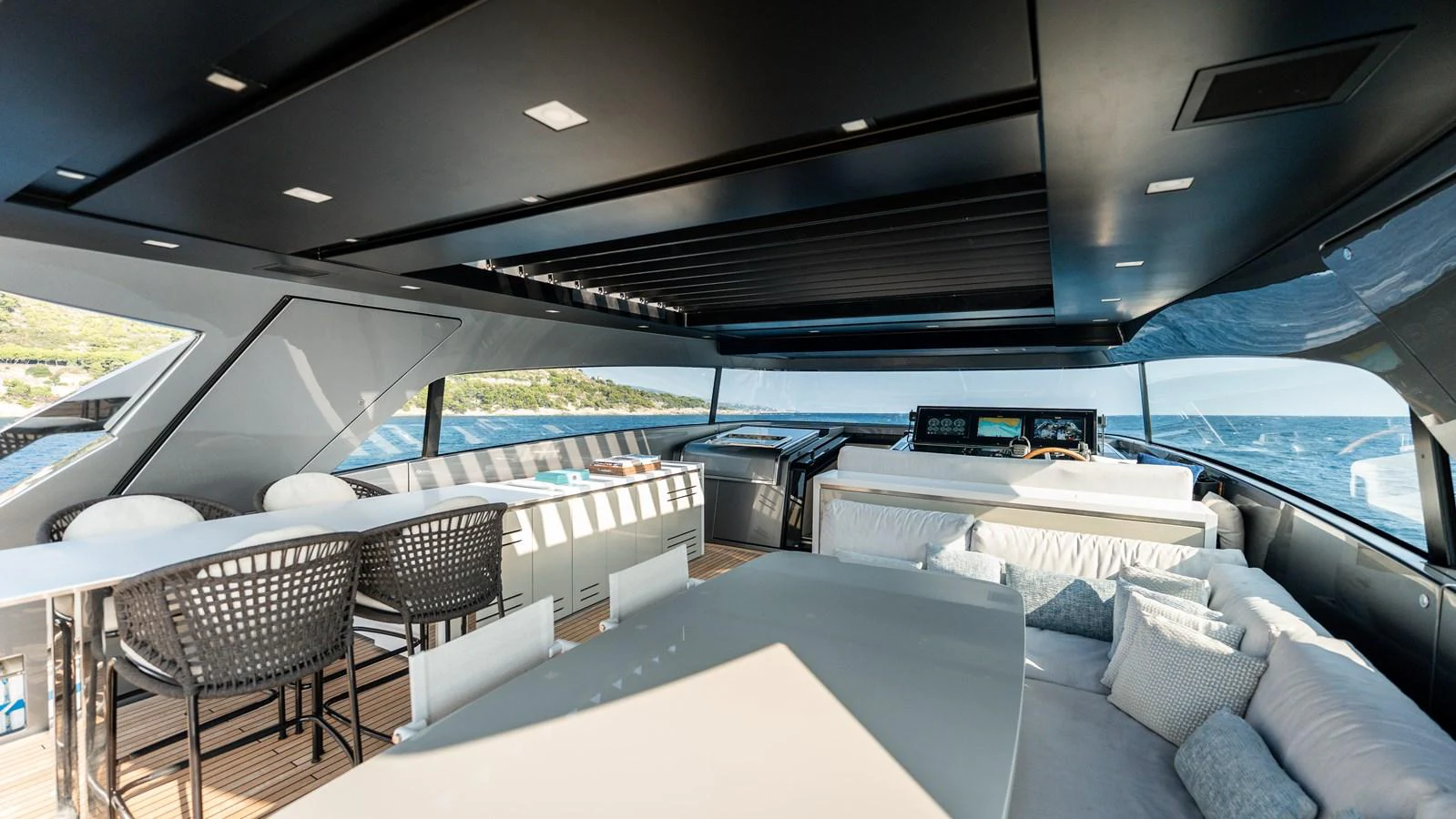 The flybridge offers a spacious and modern area with ample seating and dining options, perfect for enjoying the sea views. aboard LA Yacht for Sale