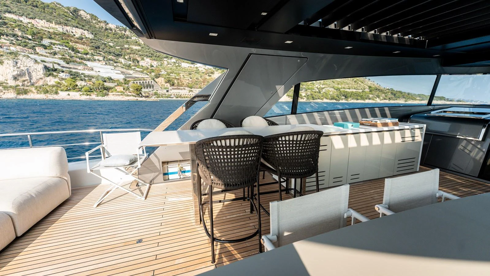 The flybridge offers a spacious and stylish area for relaxation and dining with stunning views. aboard LA Yacht for Sale