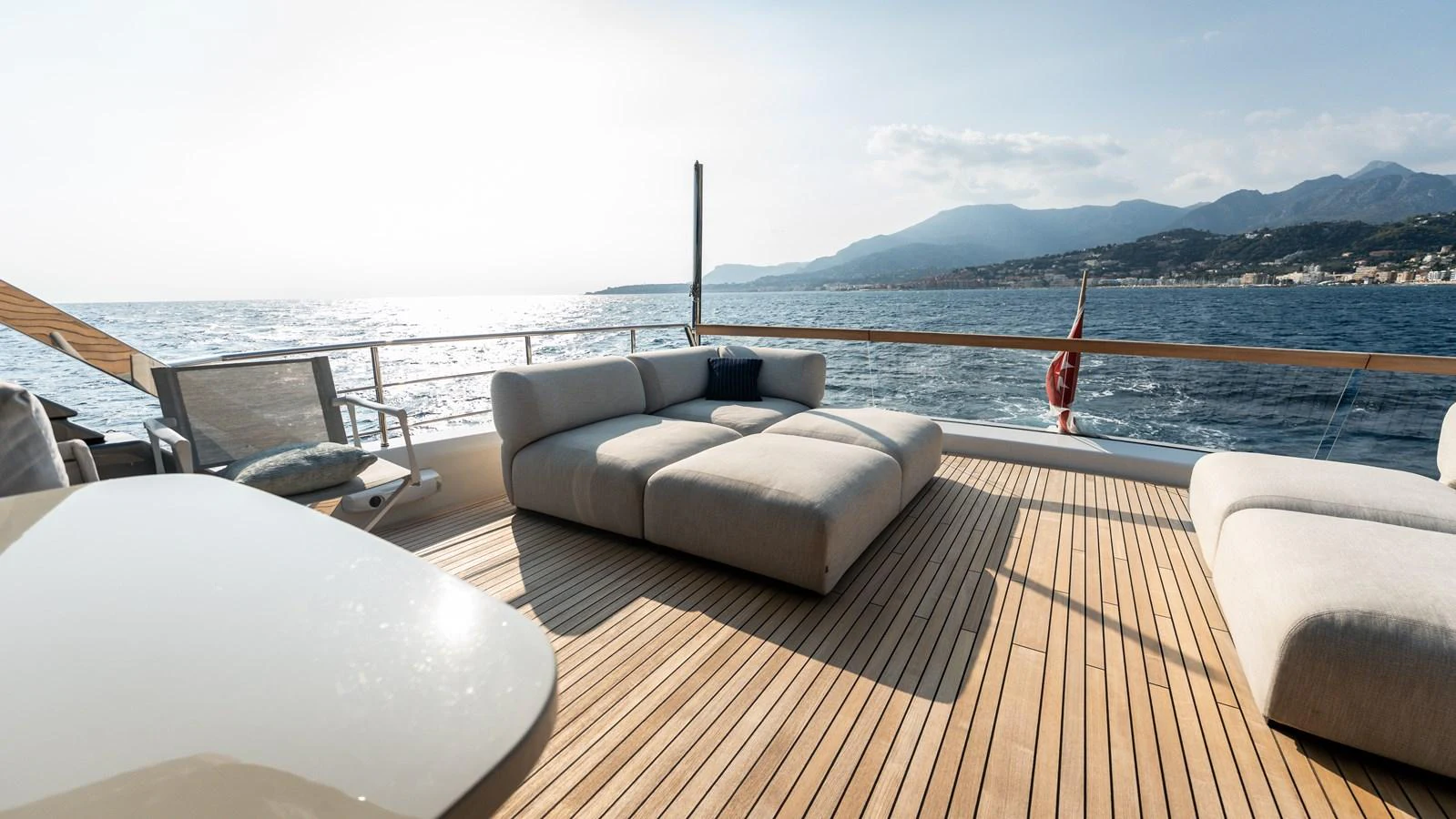 The aft deck offers a spacious lounging area with plush seating and stunning ocean views. aboard LA Yacht for Sale