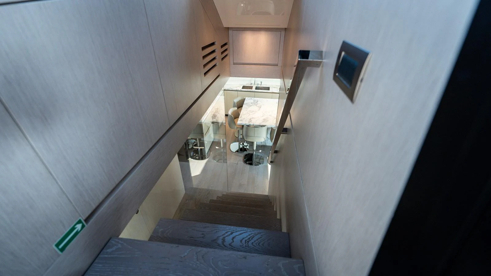 A sleek staircase leads down to a modern and stylish interior space. aboard LA Yacht for Sale