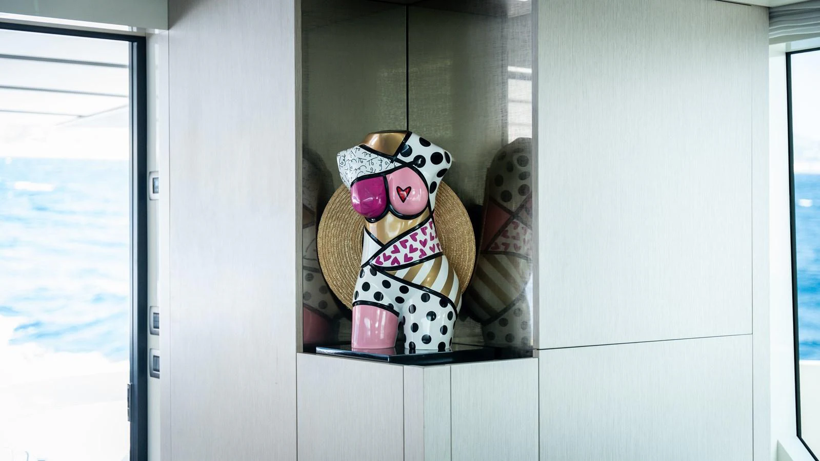 A stylish and colorful sculpture is displayed in a niche on the yacht. aboard LA Yacht for Sale