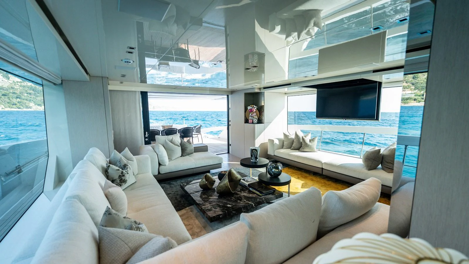 The yacht's salon offers a luxurious and spacious seating area with panoramic ocean views. aboard LA Yacht for Sale