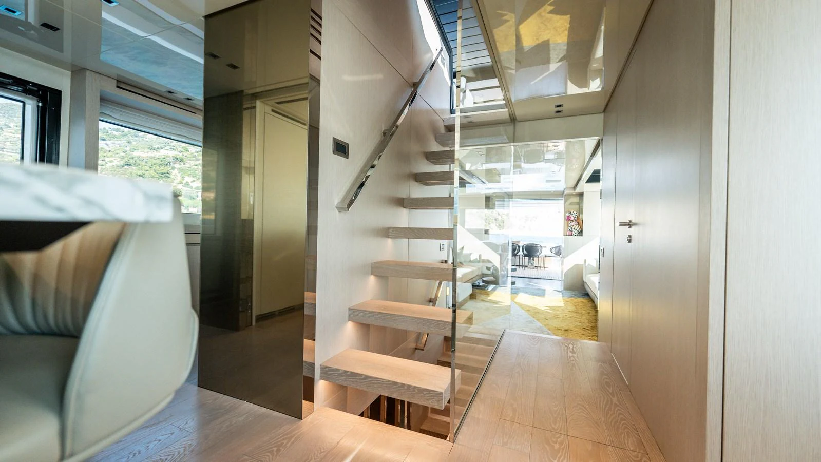 The interior features a modern staircase with sleek design elements and ample natural light. aboard LA Yacht for Sale