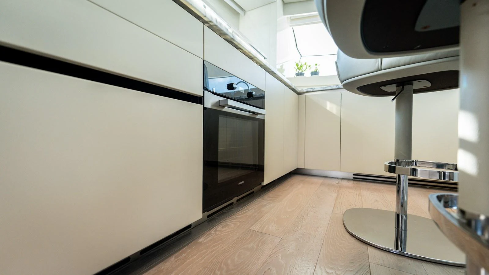 The modern galley features sleek cabinetry and state-of-the-art appliances. aboard LA Yacht for Sale