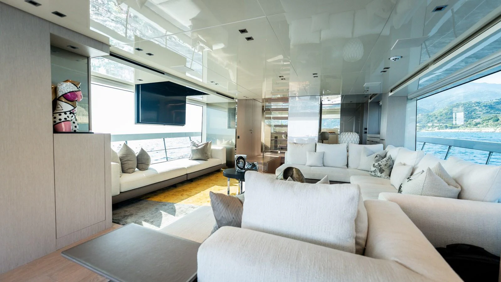 The salon features plush seating and panoramic windows for a luxurious and comfortable experience. aboard LA Yacht for Sale