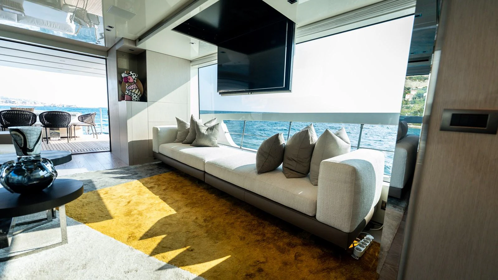 The salon features a spacious seating area with large windows offering stunning sea views. aboard LA Yacht for Sale