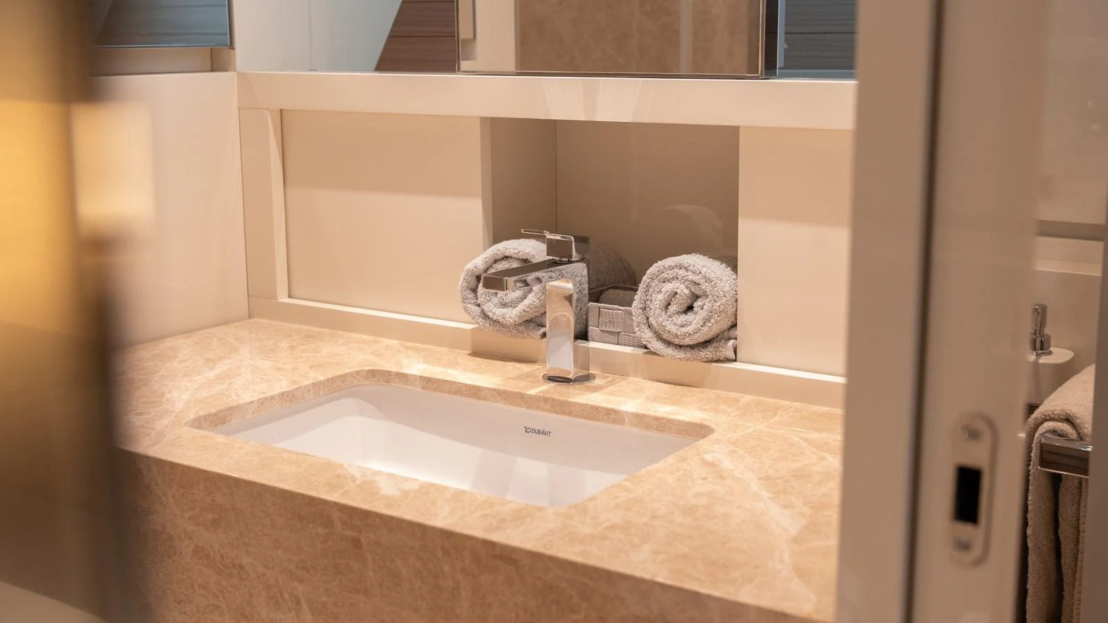 A luxurious yacht bathroom featuring a sleek sink and elegant marble countertop. aboard LA Yacht for Sale