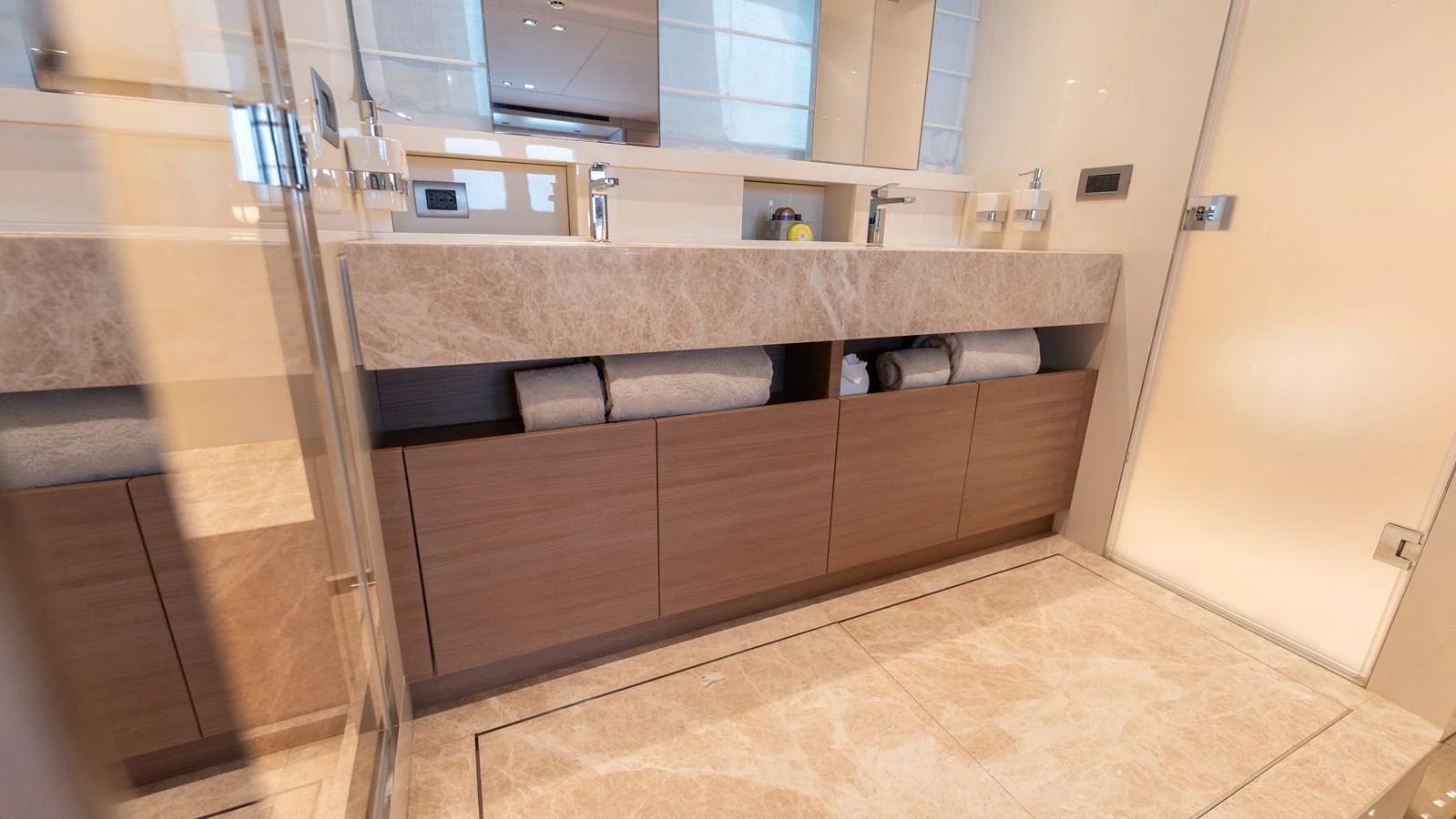 The bathroom features a sleek design with ample storage and modern fixtures. aboard LA Yacht for Sale