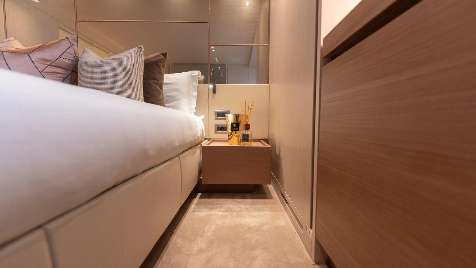 A cozy stateroom featuring a plush bed and modern decor. aboard LA Yacht for Sale