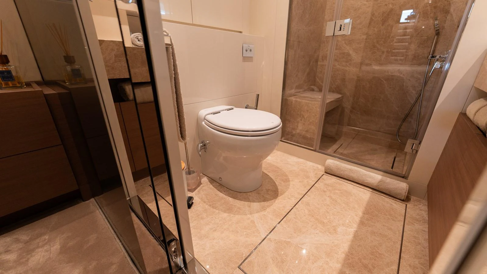 The yacht's bathroom features luxurious marble flooring and a spacious shower area. aboard LA Yacht for Sale
