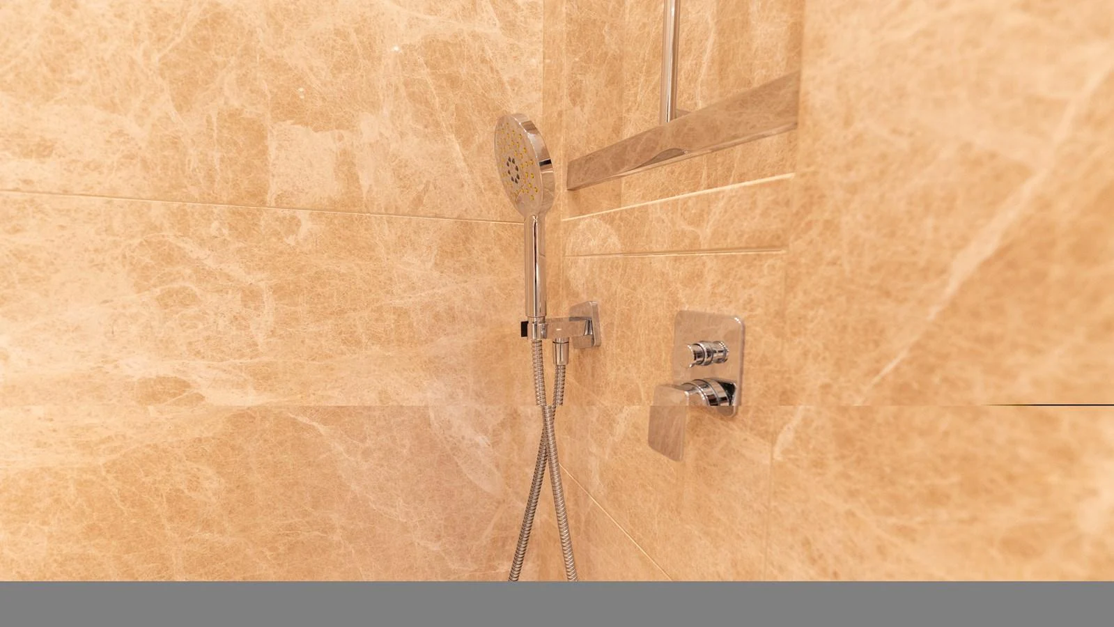 A luxurious shower with elegant marble walls and modern fixtures. aboard LA Yacht for Sale