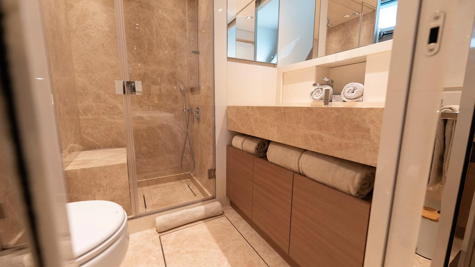 The yacht's bathroom features a spacious shower and elegant marble finishes. aboard LA Yacht for Sale