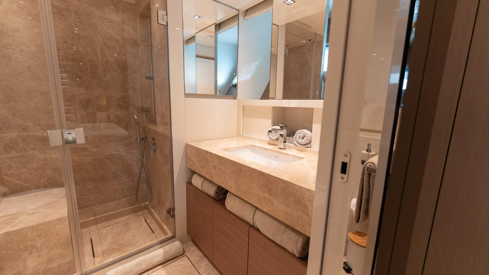 The yacht's bathroom features a spacious shower and elegant vanity with ample storage. aboard LA Yacht for Sale