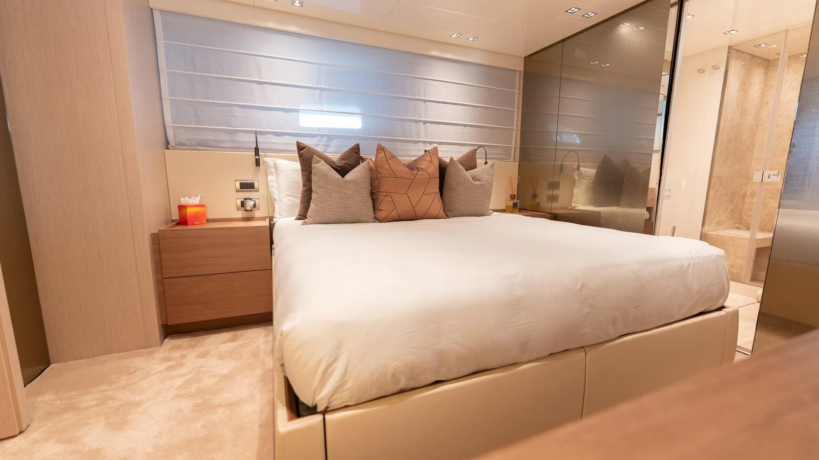 The stateroom features a plush bed with elegant decor and an en-suite bathroom. aboard LA Yacht for Sale