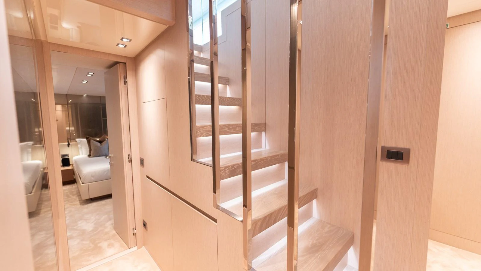 A luxurious staircase with modern lighting and sleek design elements. aboard LA Yacht for Sale