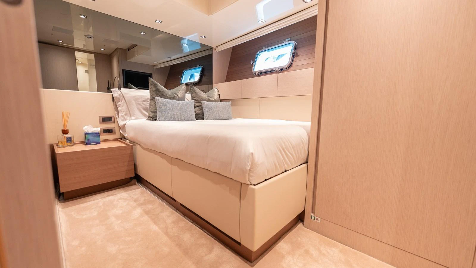 The stateroom features a plush bed with elegant bedding and modern furnishings, creating a serene retreat. aboard LA Yacht for Sale