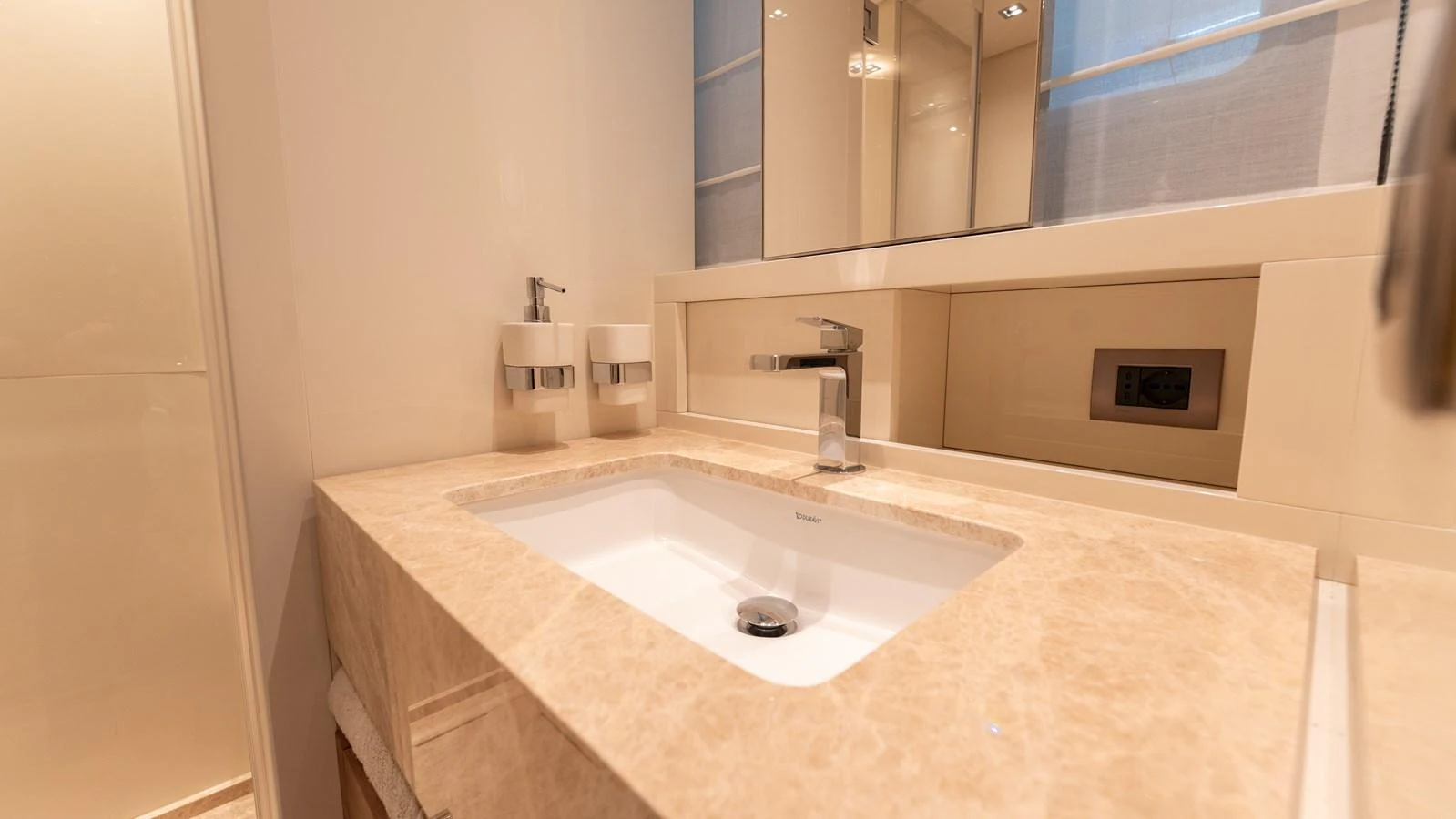 The yacht's bathroom features a sleek, modern sink with elegant fixtures and ample counter space. aboard LA Yacht for Sale