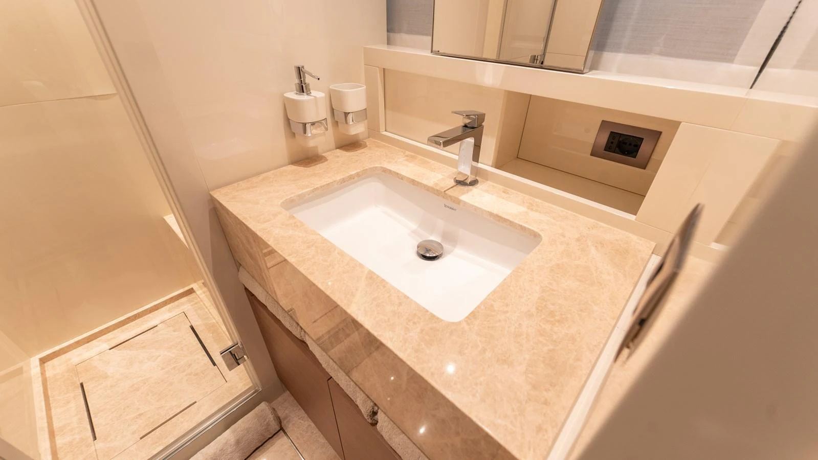 A luxurious bathroom with a sleek sink and modern fixtures. aboard LA Yacht for Sale