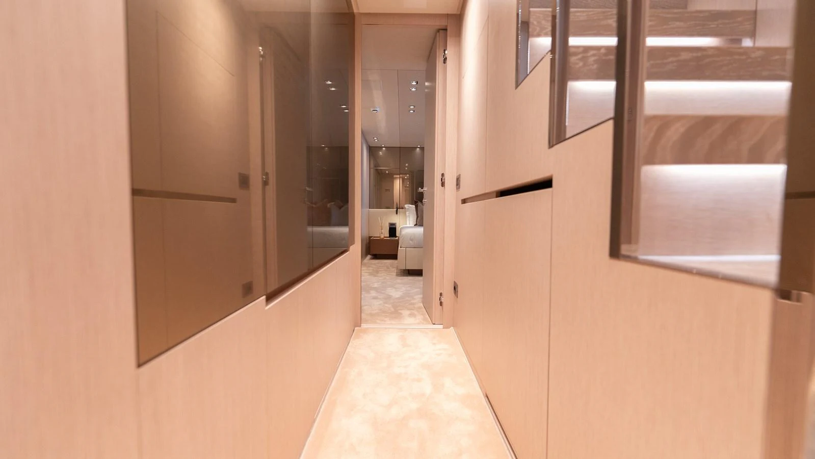 A sleek and modern hallway leads to a luxurious stateroom. aboard LA Yacht for Sale