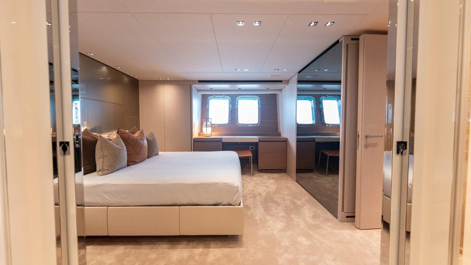 The master stateroom features a spacious bed, ample natural light, and elegant furnishings. aboard LA Yacht for Sale