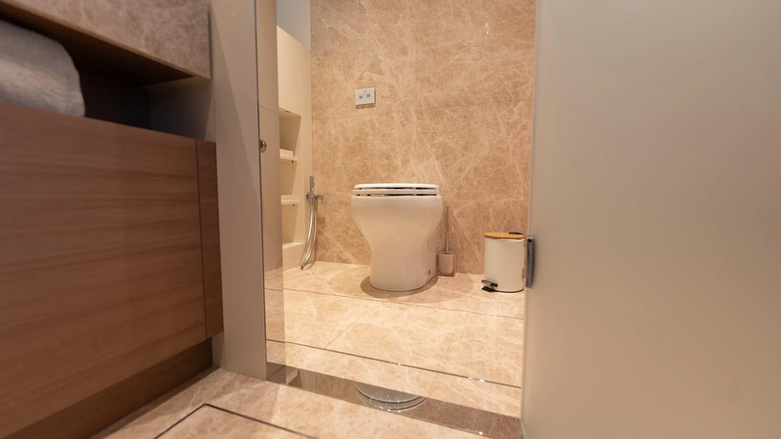 The yacht's bathroom features elegant marble flooring and modern fixtures. aboard LA Yacht for Sale