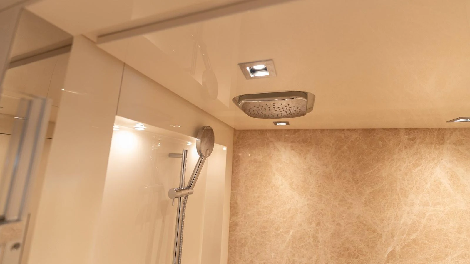 The yacht features a luxurious shower with elegant fixtures and a modern design. aboard LA Yacht for Sale