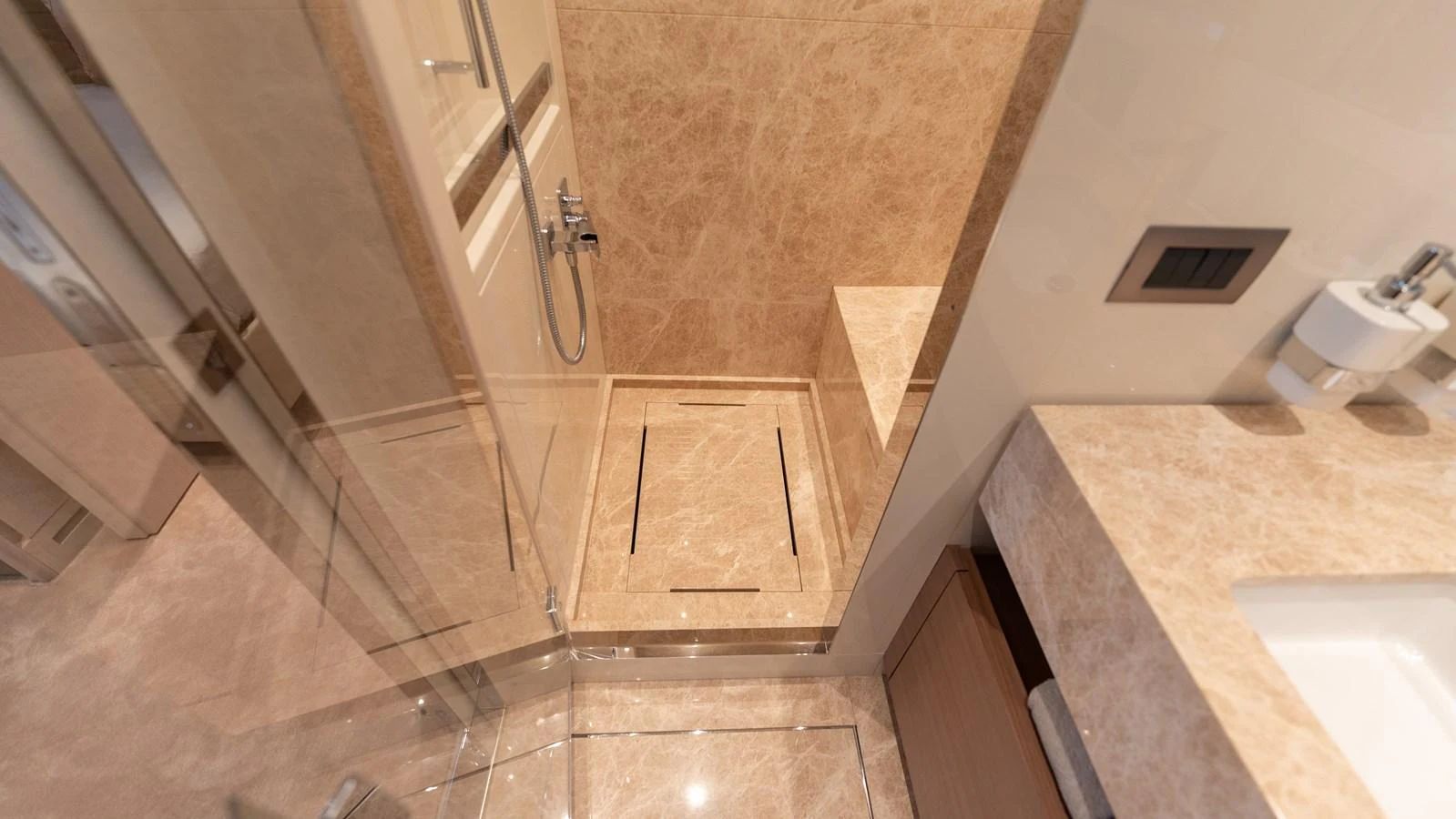 The yacht's bathroom features elegant marble surfaces and modern fixtures. aboard LA Yacht for Sale