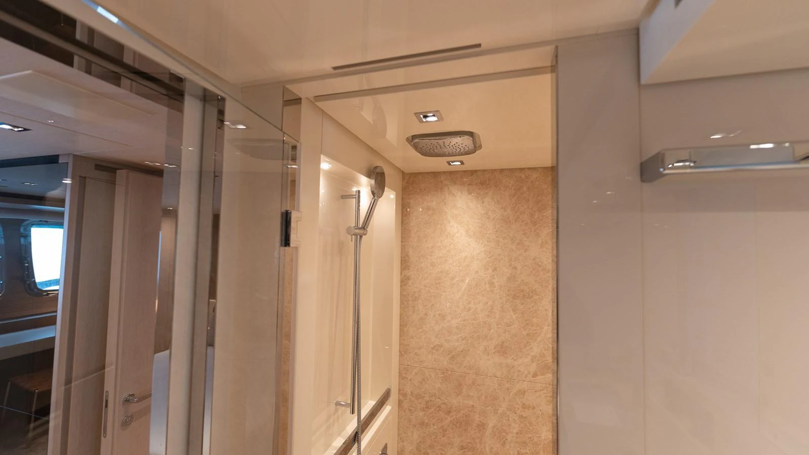 The yacht's bathroom features a sleek, modern design with high-end fixtures and a spacious shower area. aboard LA Yacht for Sale