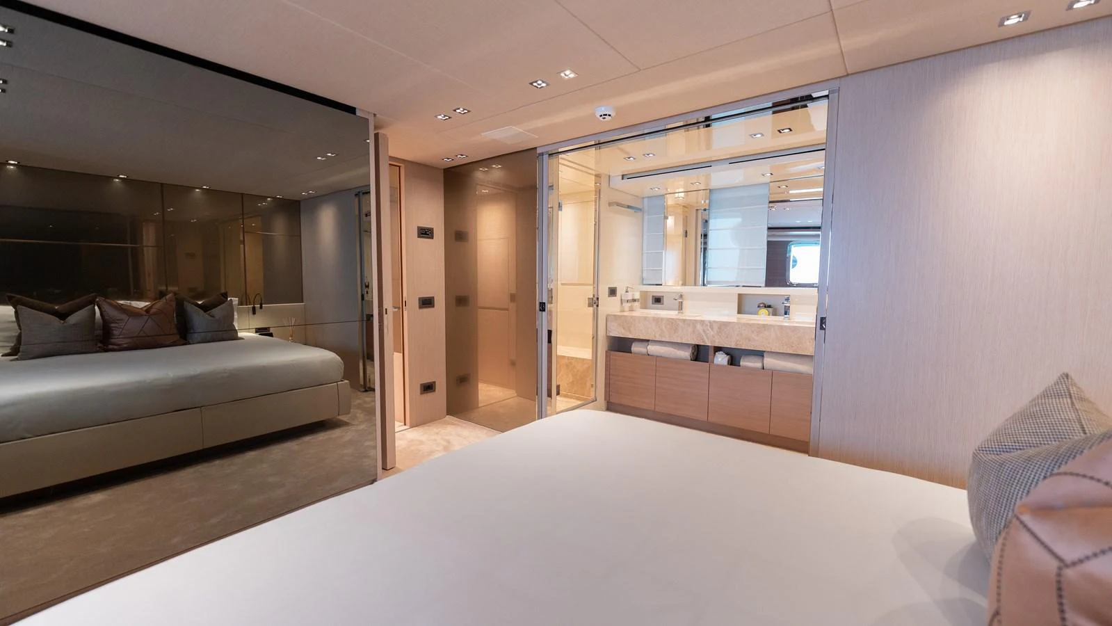 The master stateroom features a luxurious bed, ample storage, and an ensuite bathroom with modern fixtures. aboard LA Yacht for Sale