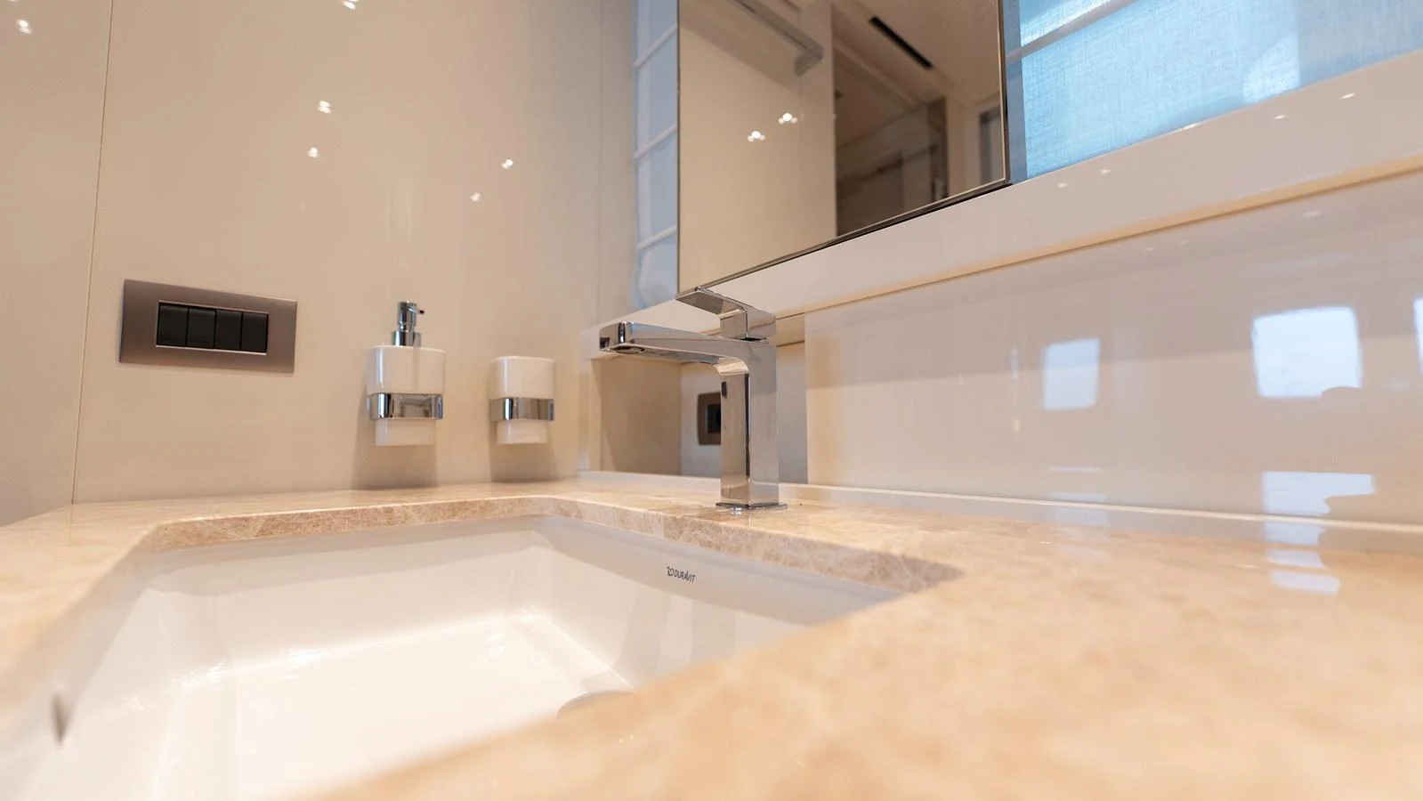 The bathroom features a modern sink with elegant fixtures and a sleek countertop. aboard LA Yacht for Sale