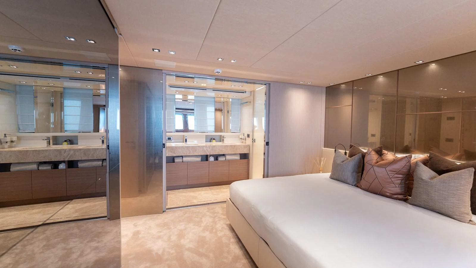 The master stateroom features a luxurious bed and an ensuite bathroom with modern fixtures. aboard LA Yacht for Sale
