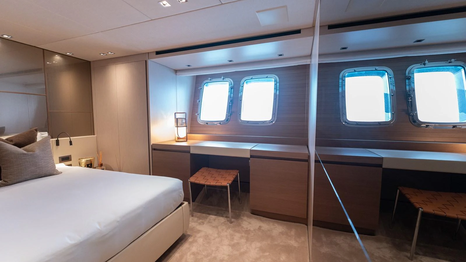 The stateroom features a modern design with large windows providing ample natural light. aboard LA Yacht for Sale