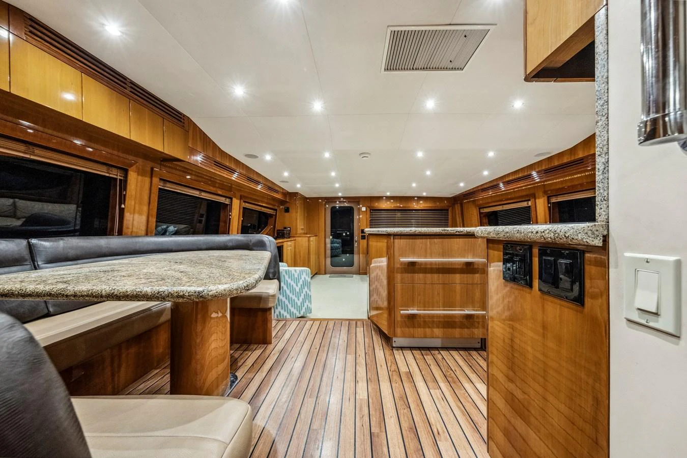 The yacht's salon features elegant wood finishes and ample seating for relaxation. aboard REEL TEXAN Yacht for Sale