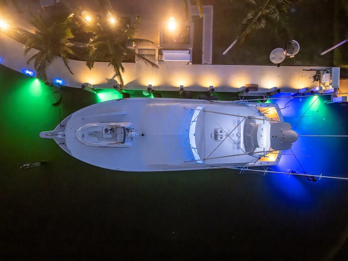 An aerial view of a yacht docked at night, illuminated by vibrant lights. aboard REEL TEXAN Yacht for Sale